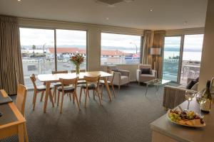 a hotel room with a table and chairs and a view at The Crown Hotel in Napier