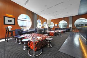 a waiting room with tables and chairs and windows at H-Residences - Gclr in Gold Coast +137 photos