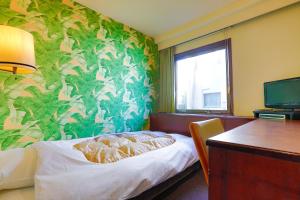 Postel nebo postele na pokoji v ubytování Hotel Los Inn Kochi