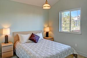 Un dormitorio con una cama con dos lámparas y una ventana. en The Vue B&B, en Seward