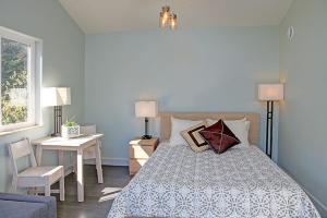 a bedroom with a bed and a table and a desk at The Vue B&B in Seward