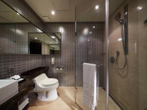 a bathroom with a shower, toilet and sink at The Tango Hotel Taipei XinYi in Taipei