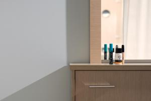 a wooden cabinet with bottles on top of it at Central Luxury Apartment in Rethymno Town