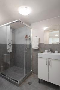 a bathroom with a shower and a sink at Central Luxury Apartment in Rethymno