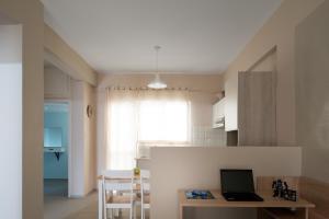 a kitchen with a desk and a laptop on a table at Central Luxury Apartment in Rethymno