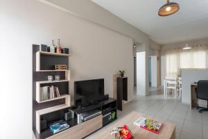 a living room with a flat screen tv on a shelf at Central Luxury Apartment in Rethymno
