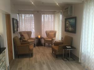 a living room with chairs and a table with a candle at Coastal Inn - Ocean City in Ocean City