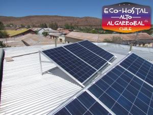 a group of solar panels on the roof of a building at Hostal Alto Algarrobal in Combarbalá