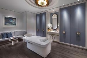 a bath room with a tub and a toilet at Crown Towers Perth in Perth