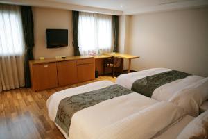 Postel nebo postele na pokoji v ubytování Daegu Union Tourist Hotel + 12 fotografií