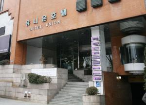 a building with a sign in front of it at Daegu Union Tourist Hotel in Daegu