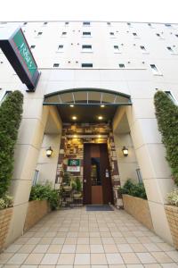 ein Gebäude mit einem Flur, der zu einer Tür führt in der Unterkunft R&B Hotel Sendai Hirosedori Ekimae in Sendai