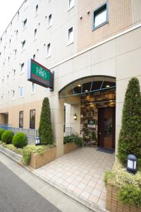
a building with a sign on the front of it at R&B Hotel Sendai Hirosedori Ekimae in Sendai
