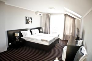 Кровать или кровати в номере Pensiunea Belanco