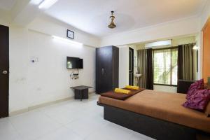 a bedroom with a large bed in a room at Sea Land Kihim in Alibaug