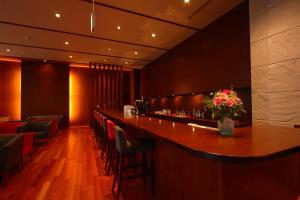 a bar in a restaurant with a vase of flowers at Premier Resort Yuga Ise Shima in Shima