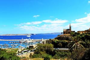 a view of a harbor with boats in the water at Seaview Luxury Penthouse with Shared Swimming Pool in Għajnsielem