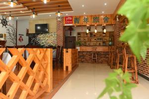 a restaurant with wooden walls and a bar at Huangshan Tangkou Haoshi International Youth Hostel in Huangshan Scenic Area