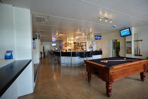 a room with a pool table and a bar at Commercial Hotel in Charters Towers