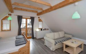 a living room with a couch and a table at Rustic House 13 in Bohinj