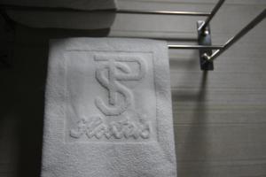 a towel with a dollar sign on it on a rack at Hostal Roma in Seville