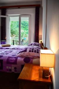a bedroom with a purple bed and a window at Accommodation Drasko in Korčula