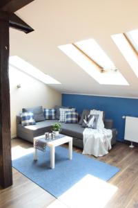 a living room with a couch and a table at Blooms Inn & Apartments in Poznań