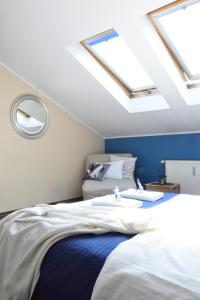 a bedroom with a bed with skylights at Blooms Inn & Apartments in Poznań