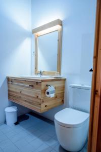 a bathroom with a white toilet and a sink at Casa Branca do Imperio in Cinco Ribeiras