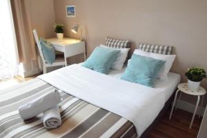 1 dormitorio con 1 cama con almohadas azules en Blooms Inn & Apartments en Poznan