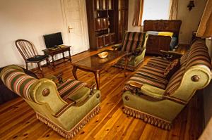 a living room with two couches and a table at Vila Jelita in Nida