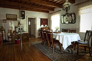 a dining room with a white table and chairs at Vila Jelita in Nida