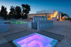 a pool with a hot tub in front of a house at Tenuta del Lauro in Locorotondo