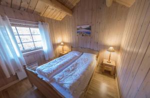 En eller flere senger på et rom på Rondane Hytter og Leiligheter