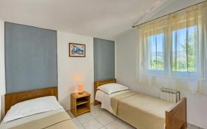 Posteľ alebo postele v izbe v ubytovaní Apartments & Bungalows Ivanović