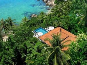 an aerial view of a house with a swimming pool at Trisara - SHA Plus in Nai Thon Beach