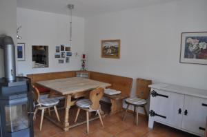 a kitchen with a wooden table and chairs in it at Ferienhaus Wilder Kaiser in Kiefersfelden