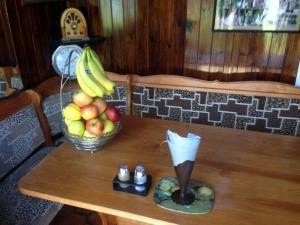 a table with a bowl of fruit and a funnel at Liverpool Airport Rooms in Speke