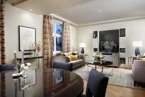 a living room with a couch and a table at Taj 51 Buckingham Gate Suites and Residences in London