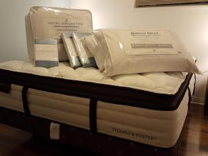 a mattress with two boxes on top of it at Emperial Suites in North Vancouver