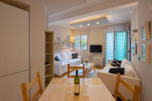 a living room with a table with a wine bottle on it at Apia Residence in Budva