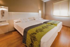 Postel nebo postele na pokoji v ubytování Hotel Fuente El Cura