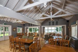 a dining room with wooden tables and chairs at Lusty Beg Island in Kesh