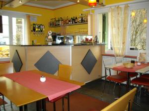 a restaurant with two tables and a bar at Hotel Klein Matterhorn in Randa