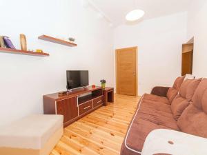 a living room with a couch and a tv at Apartments Kaleta in Kotor +23 photos