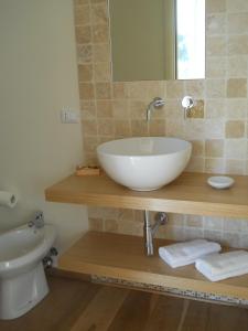 a bathroom with a white sink and a toilet at Al Coppo in Sirolo