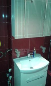 a bathroom with a sink and a mirror at Garsoniera Delia in Constanţa +12 photos