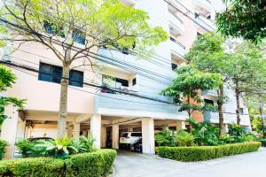 an apartment building with a car parked in it at Grand Residence Ngamwongwan 19 in Nonthaburi