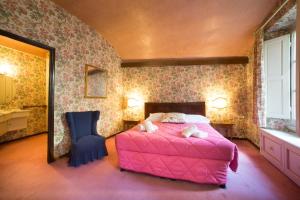 a bedroom with a pink bed and a chair at Vigna2 - Big 2 bedroom apartment in Florence center in Florence