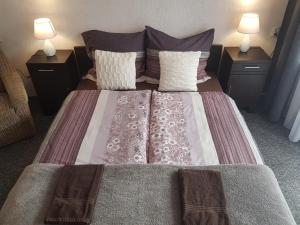 a large bed with two night stands and two lamps at Willa Grafit in Karpacz +63 photos